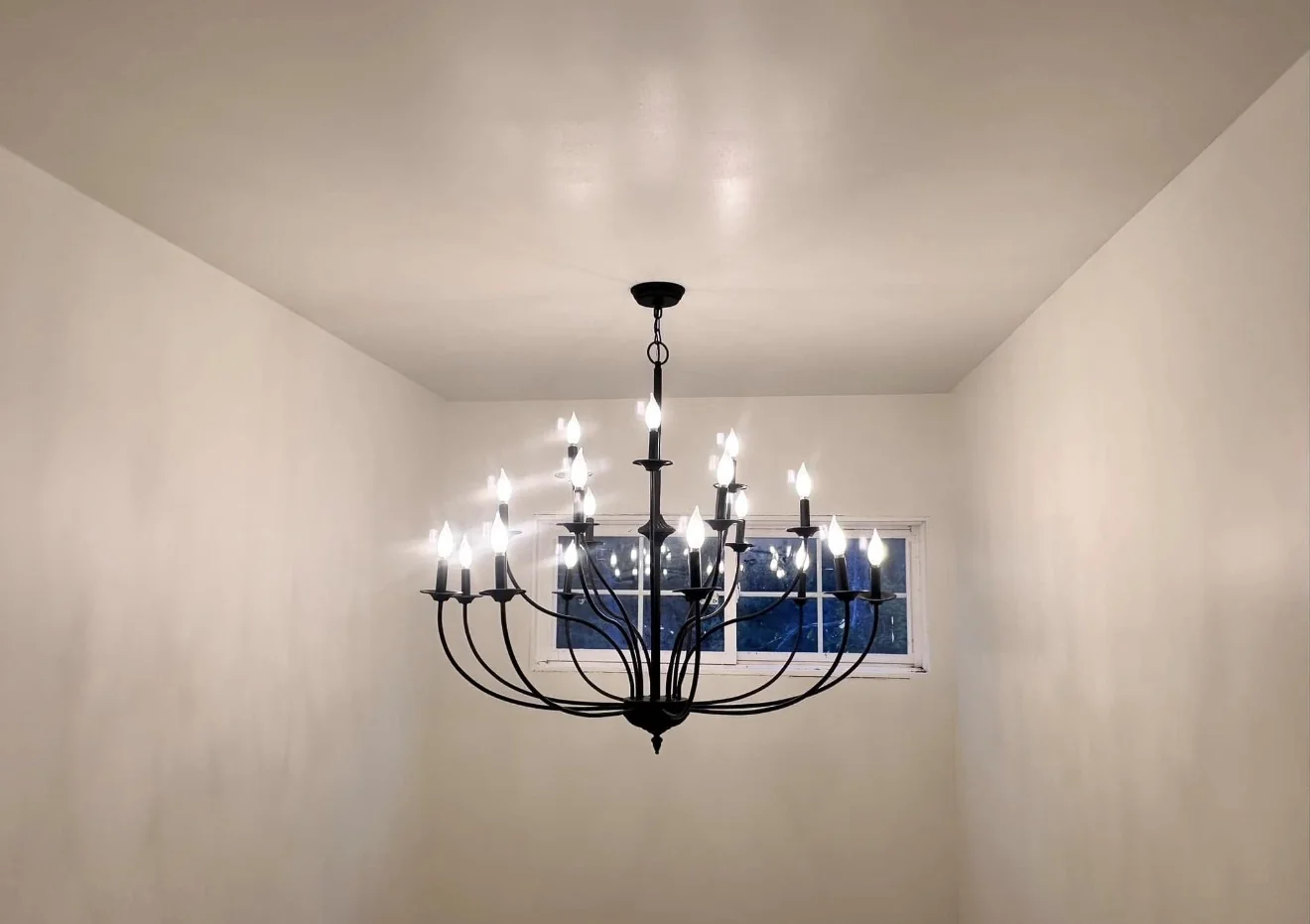 Large illuminated chandelier in a high-ceiling room