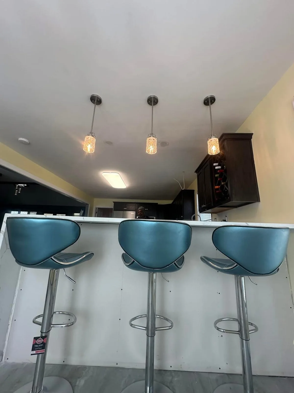Three pendant lights above a residential counter